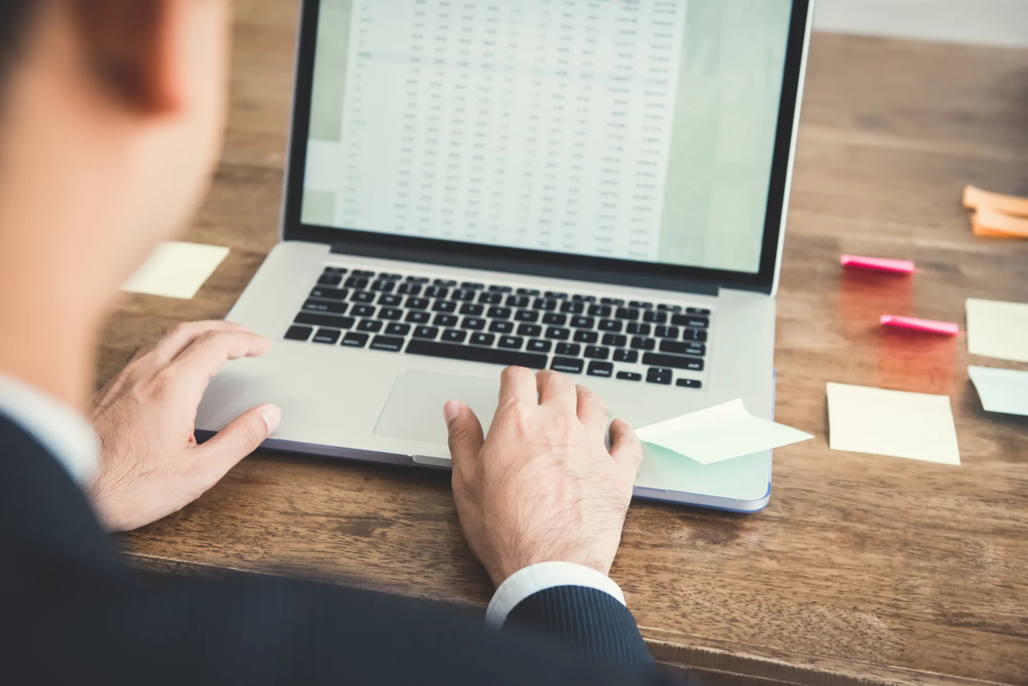businessman-concentrating-using-laptop-computer-analysing-data-screen